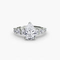 The Graduated Accent Ring in white gold with a pear-shaped centre stone