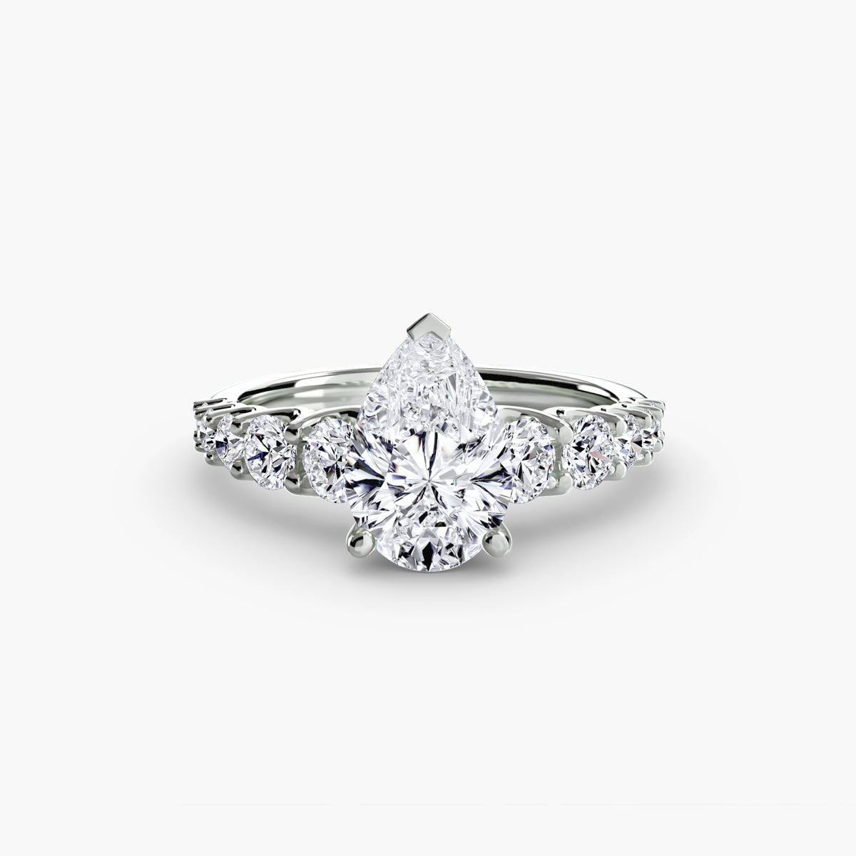 The Graduated Accent Ring in white gold with a pear-shaped centre stone