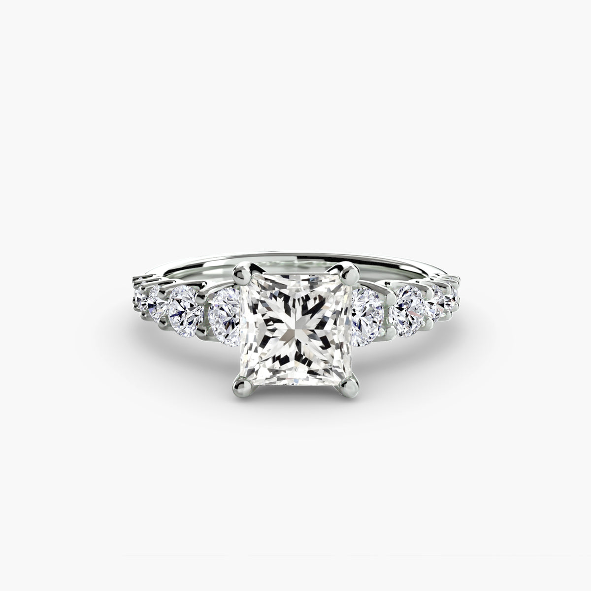 The Graduated Accent Ring in white gold with a princess-cut centre stone