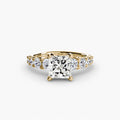 The Graduated Accent Ring in yellow gold with a princess-cut centre stone