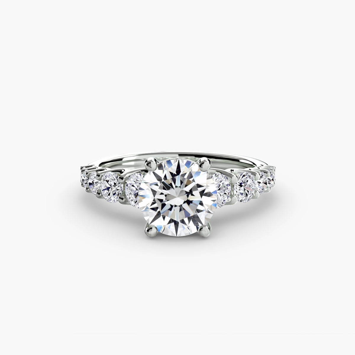 The Graduated Accent Ring in white gold with a round centre stone