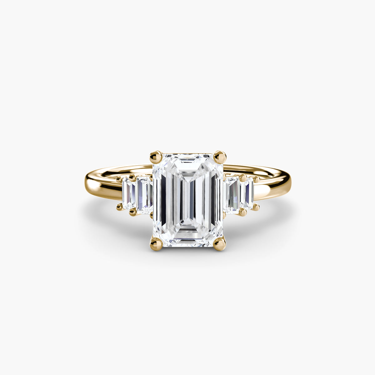Baguette Accent Solitaire engagement ring in yellow gold with an emerald-cut centre stone