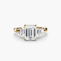 Baguette Accent Solitaire engagement ring in yellow gold with an emerald-cut centre stone