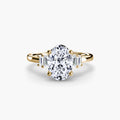 Baguette Accent Solitaire engagement ring in yellow gold with an oval centre stone