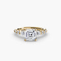 The Tiered Accent Ring in yellow gold with an Asscher-cut centre stone