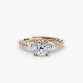 The Tiered Accent Ring in yellow gold with a cushion-cut centre stone