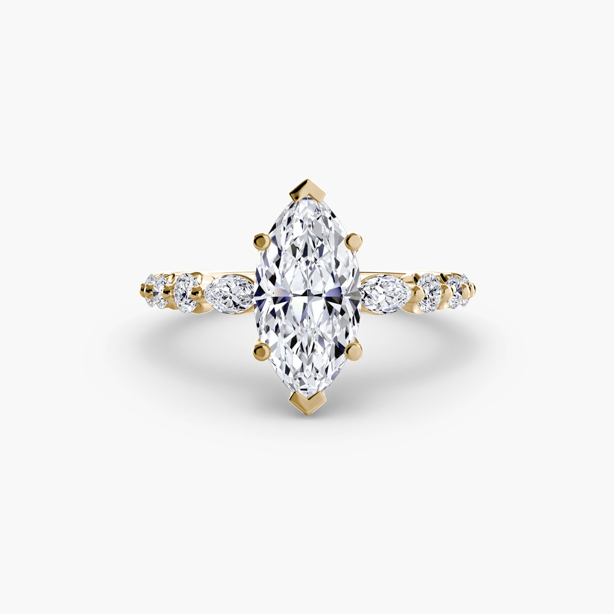 The Tiered Accent Ring in yellow gold with a marquise centre stone