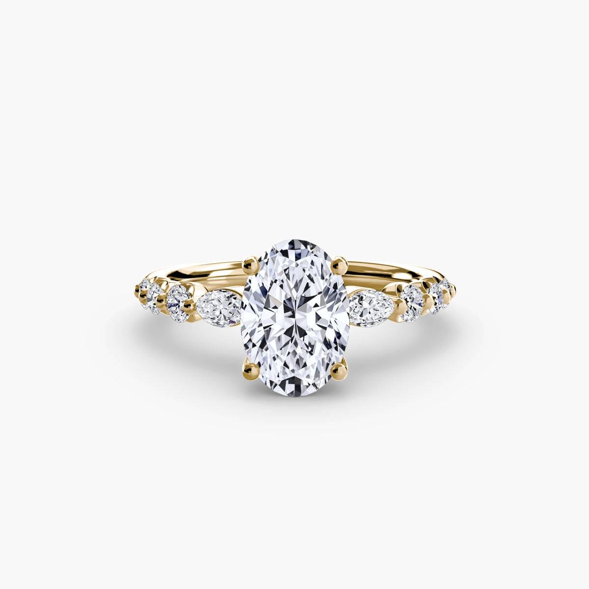 The Tiered Accent Ring in yellow gold with an oval centre stone