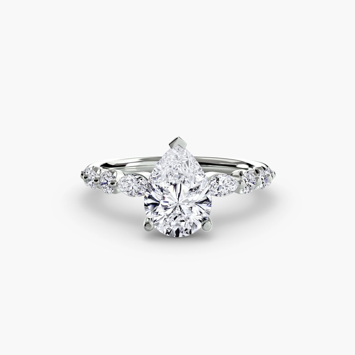 The Tiered Accent Ring in white gold with a pear-shaped centre stone