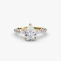 The Tiered Accent Ring in yellow gold with a pear-shaped centre stone