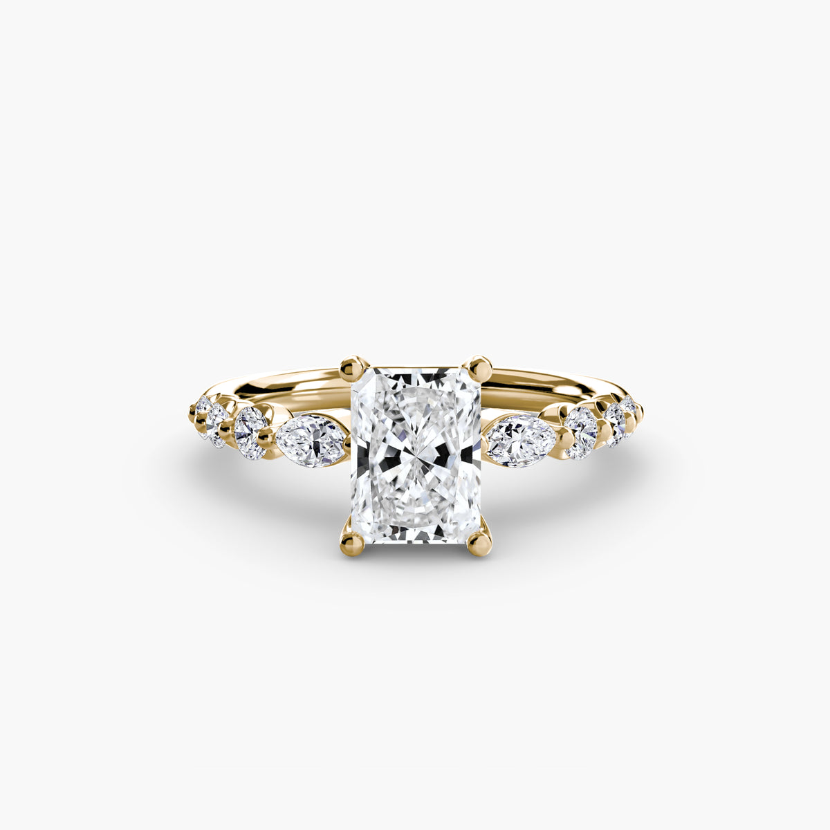 The Tiered Accent Ring in yellow gold with a radiant-cut centre stone