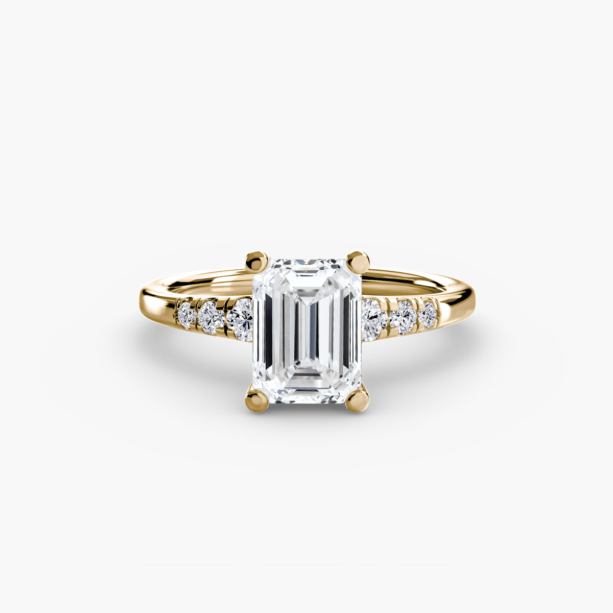 Solitaire with Shoulder Accents engagement ring in yellow gold with an emerald-cut centre stone