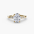 Solitaire with Shoulder Accents engagement ring in yellow gold with an oval centre stone