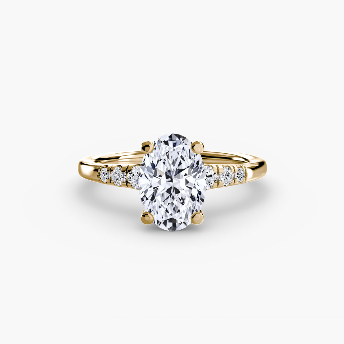 Solitaire with Shoulder Accents engagement ring in yellow gold with an oval centre stone