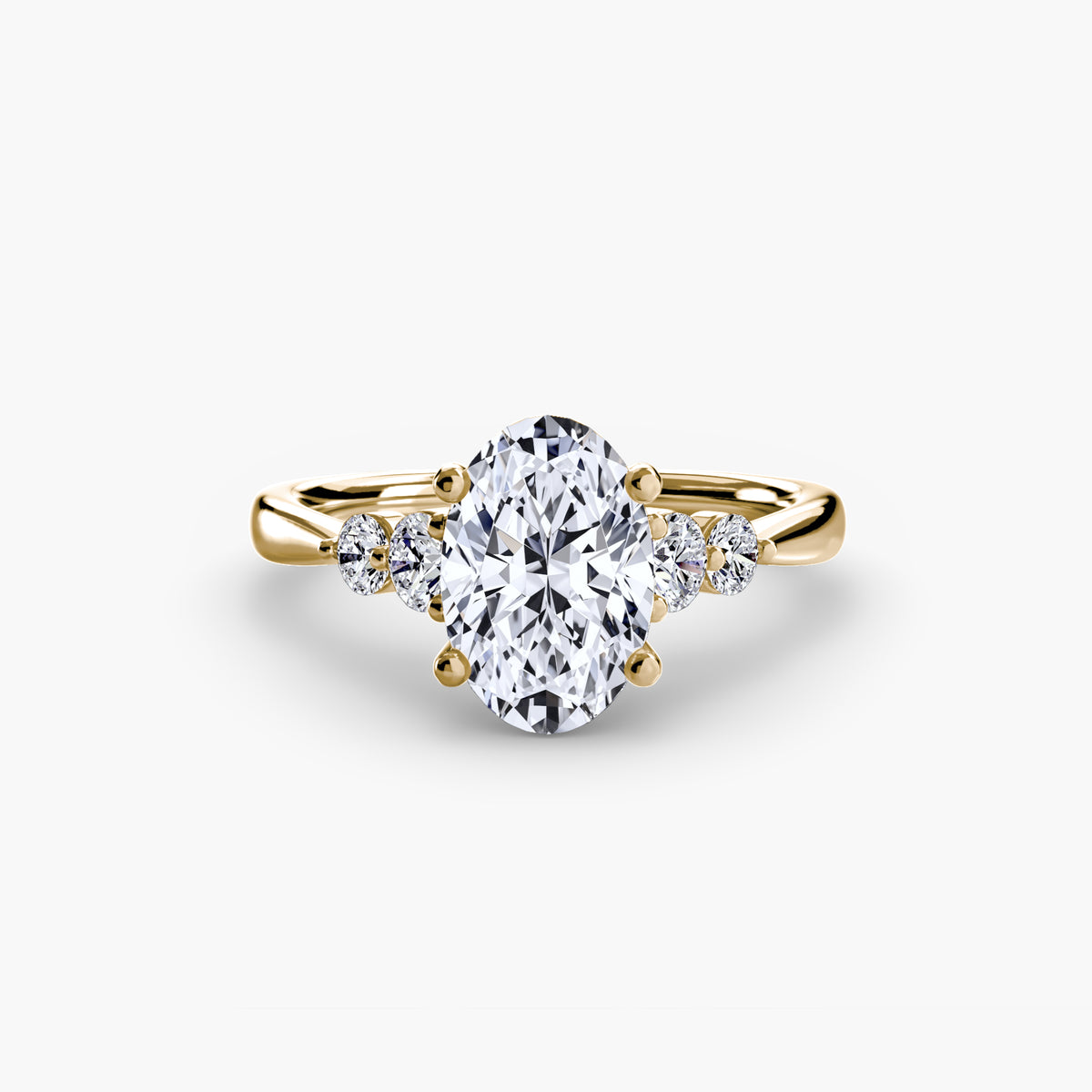 Solitaire with Shoulder Accents engagement ring in yellow gold with an oval centre stone