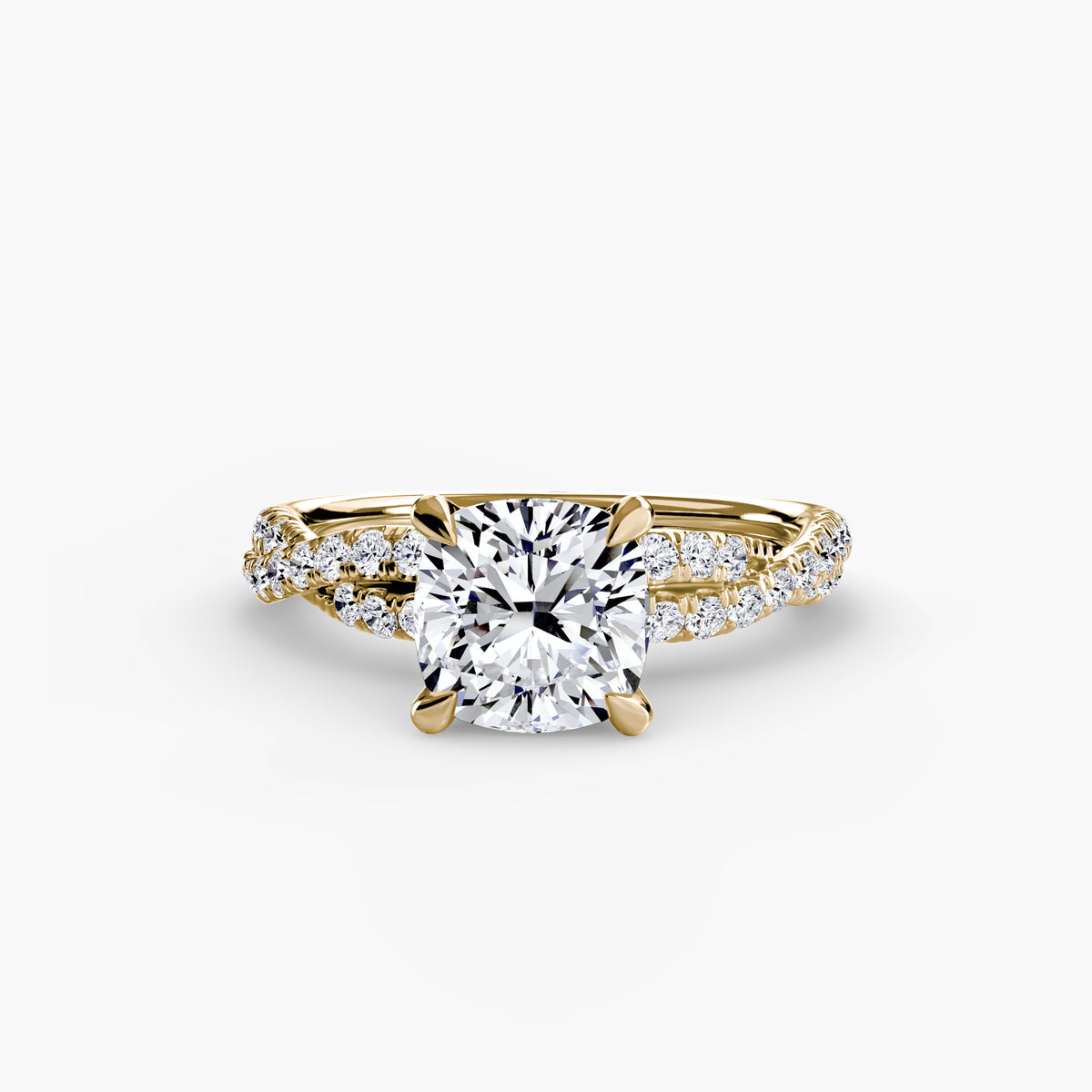 The Twisted Pavé Solitaire engagement ring in yellow gold with a cushion-cut centre stone