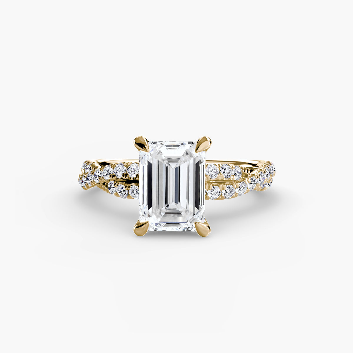 The Twisted Pavé Solitaire engagement ring in yellow gold with an emerald-cut centre stone