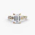 The Twisted Pavé Solitaire engagement ring in yellow gold with an emerald-cut centre stone