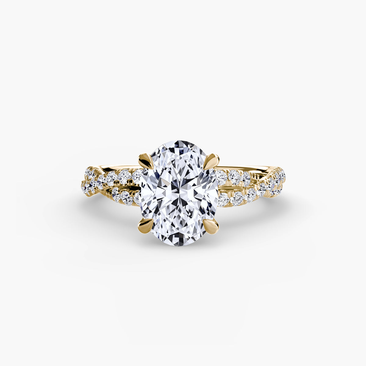 The Twisted Pavé Solitaire engagement ring in yellow gold with an oval centre stone