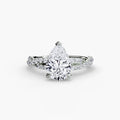 The Twisted Pavé Solitaire engagement ring in white gold with a pear-shaped centre stone