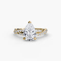 The Twisted Pavé Solitaire engagement ring in yellow gold with a pear-shaped centre stone