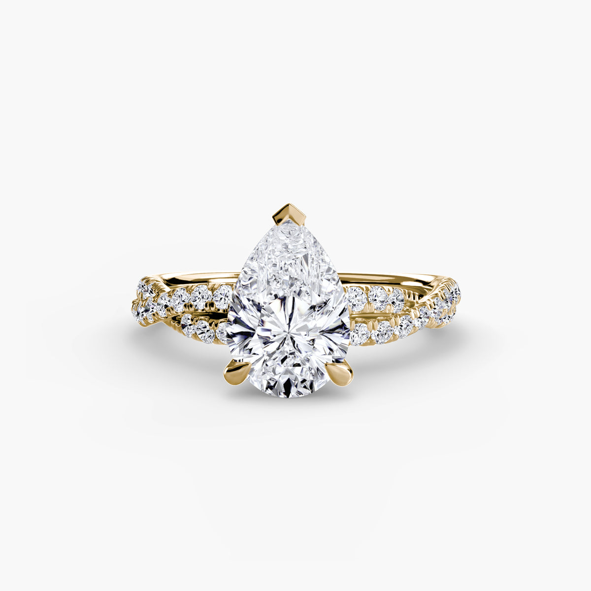The Twisted Pavé Solitaire engagement ring in yellow gold with a pear-shaped centre stone