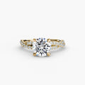 The Twisted Pavé Solitaire engagement ring in yellow gold with a round centre stone
