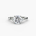 Solitaire with Cluster Shoulders engagement ring in white gold with a round centre stone