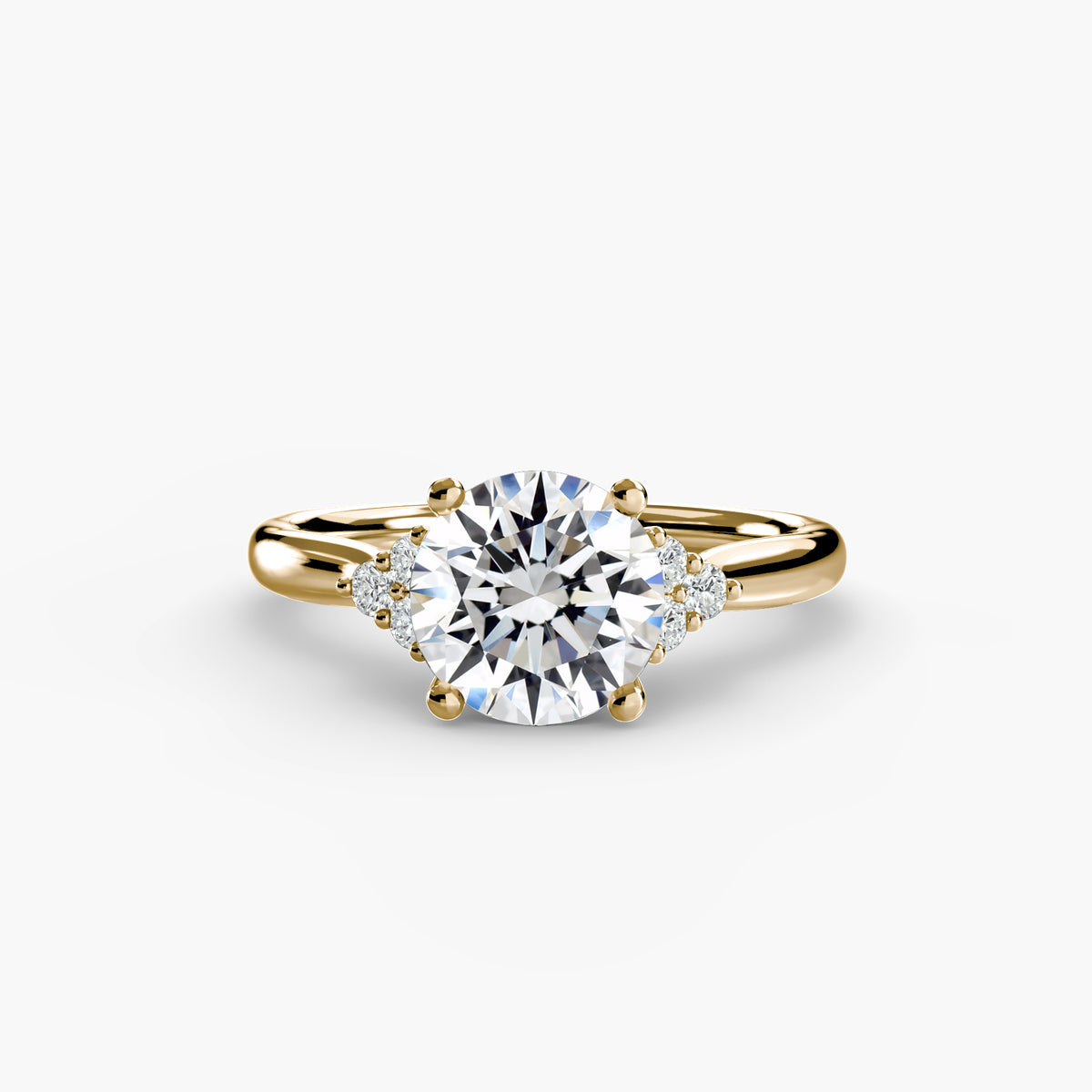 Solitaire with Cluster Shoulders engagement ring in yellow gold with a round centre stone