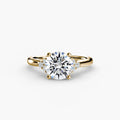 Solitaire with Cluster Shoulders engagement ring in yellow gold with a round centre stone