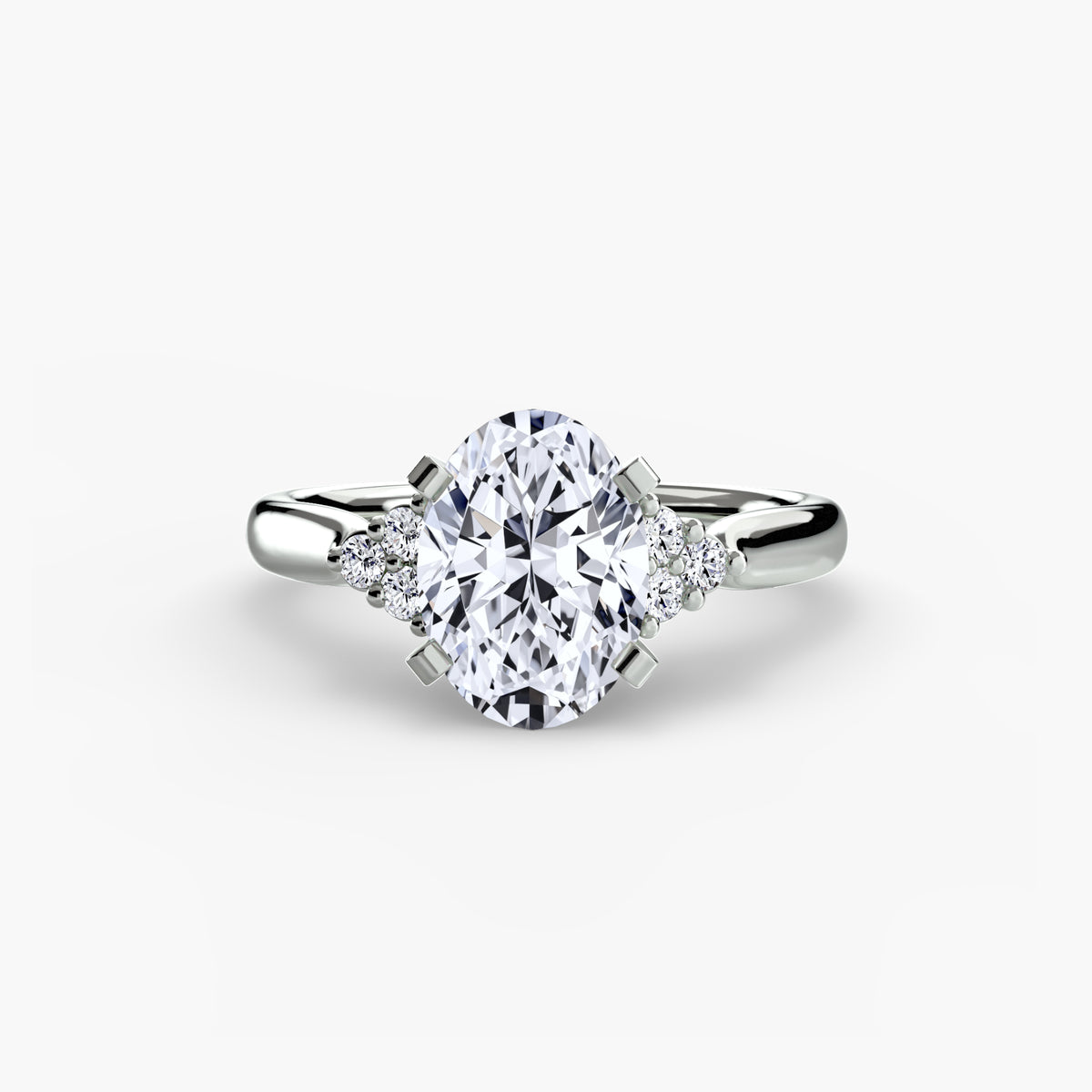 Solitaire with Cluster Shoulders engagement ring in white gold with an oval centre stone