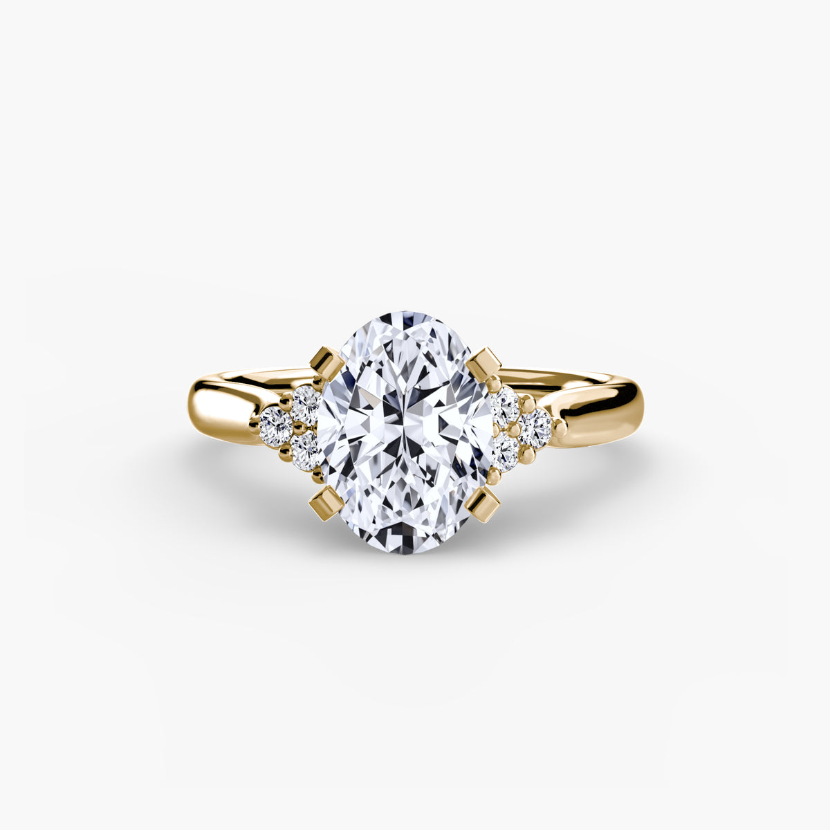 Solitaire with Cluster Shoulders engagement ring in yellow gold with an oval centre stone
