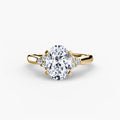 Solitaire with Cluster Shoulders engagement ring in yellow gold with an oval centre stone