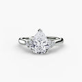 Solitaire with Cluster Shoulders engagement ring in white gold with a pear-shaped centre stone