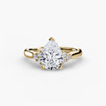 Solitaire with Cluster Shoulders engagement ring in yellow gold with a pear-shaped centre stone