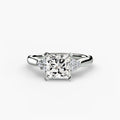 Solitaire with Cluster Shoulders engagement ring in white gold with a princess-cut centre stone