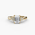Solitaire with Cluster Shoulders engagement ring in yellow gold with an emerald-cut centre stone