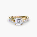 The Emerald Twist Pavé Ring in yellow gold with an Asscher-cut centre stone