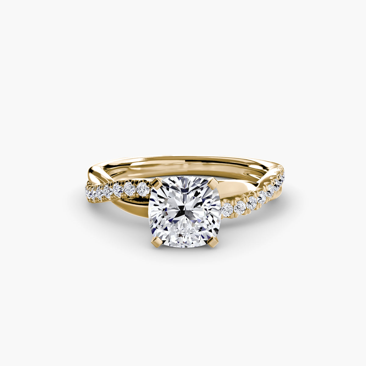 The Emerald Twist Pavé Ring in yellow gold with a cushion-cut centre stone