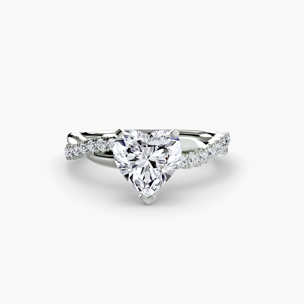 The Emerald Twist Pavé Ring in white gold with a heart-shaped centre stone