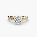 The Emerald Twist Pavé Ring in yellow gold with a heart-shaped centre stone