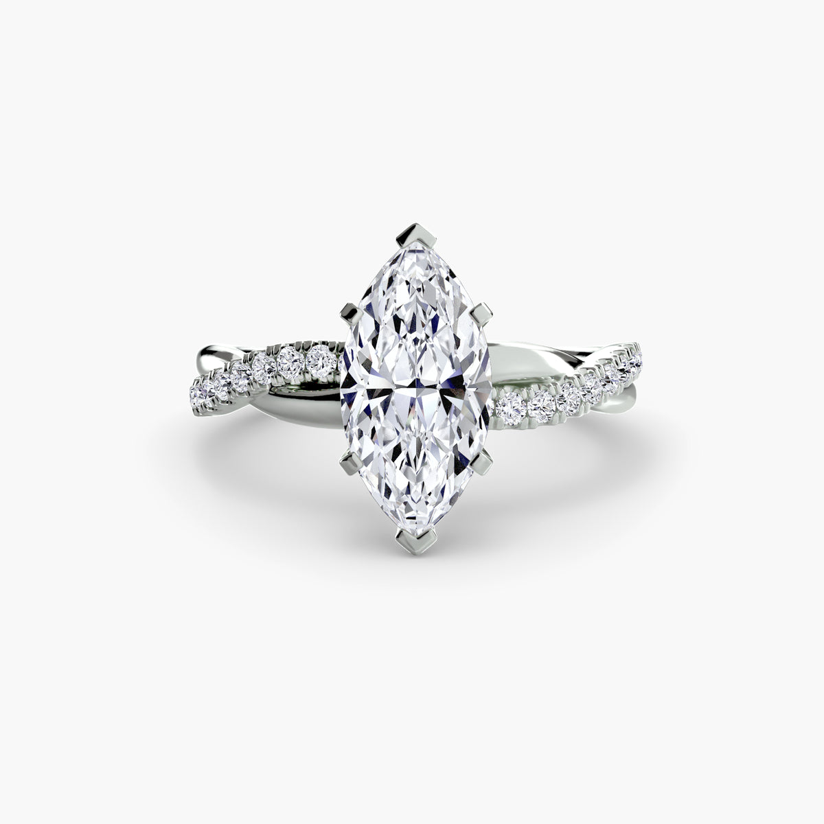 The Emerald Twist Pavé Ring in white gold with a marquise centre stone