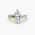 The Emerald Twist Pavé Ring in yellow gold with a marquise centre stone