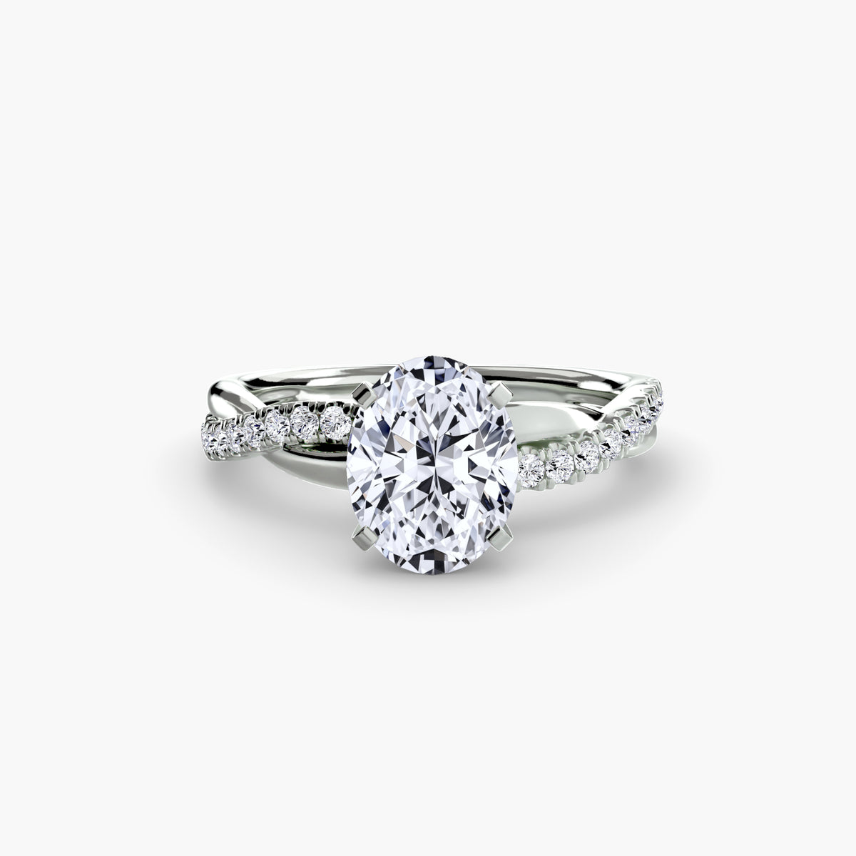 The Emerald Twist Pavé Ring in white gold with an oval centre stone