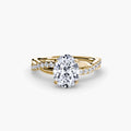 The Emerald Twist Pavé Ring in yellow gold with an oval centre stone