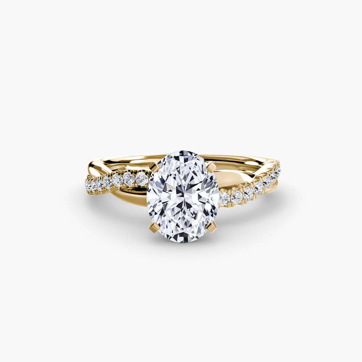The Emerald Twist Pavé Ring in yellow gold with an oval centre stone