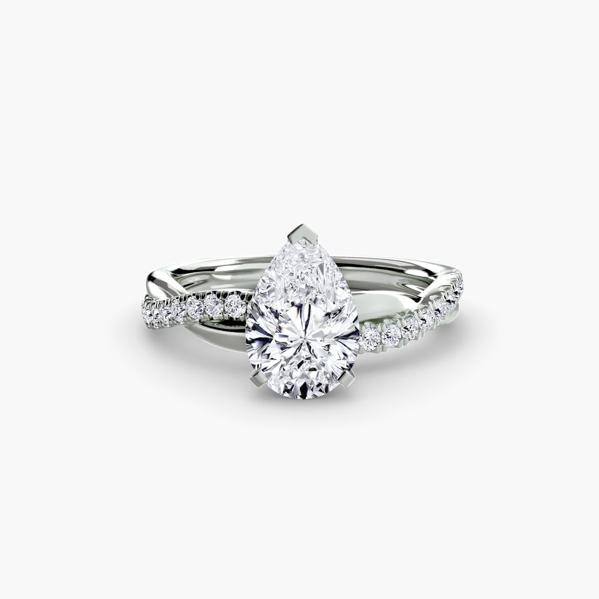 The Emerald Twist Pavé Ring in white gold with a pear-shaped centre stone
