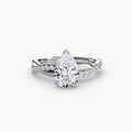 The Emerald Twist Pavé Ring in white gold with a pear-shaped centre stone