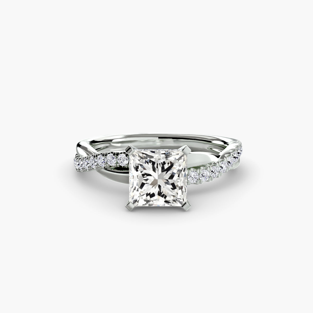 The Emerald Twist Pavé Ring in white gold with a princess-cut centre stone