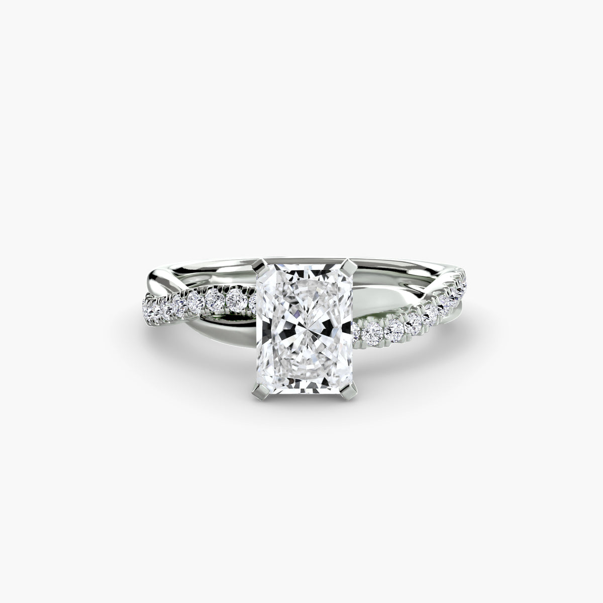 The Emerald Twist Pavé Ring in white gold with a radiant-cut centre stone